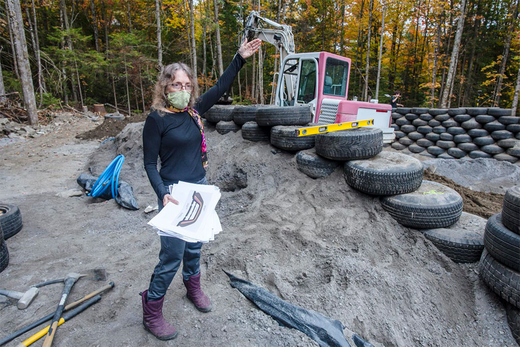 Liz Hatch explains the design features of her earthship home under construction in Greensboro on Friday, September 25, 2020.